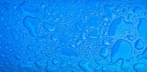 Καθαρές σταγόνες νερού στην μπλε επιφάνεια. Banner για την εταιρεία ύδρευσης. - Φωτογραφία, εικόνα