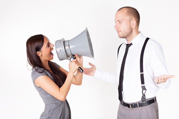 Businesswoman shouting at a businessman with megaphone - Valokuva, kuva