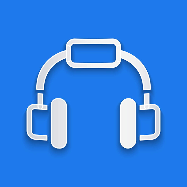 Papel corte Headphones ícone isolado no fundo azul. Fones de ouvido. Conceito para ouvir música, serviço, comunicação e operador. Estilo de arte de papel. Vetor - Vetor, Imagem
