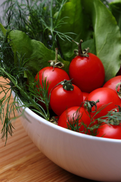 Fresh organic cherry tomatoes and green onions dill in a bowl - Fotoğraf, Görsel