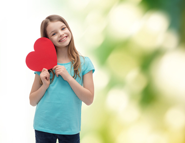smiling little girl with red heart - Фото, изображение