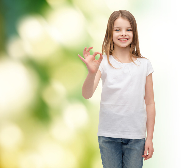 little girl in white t-shirt showing ok gesture - Foto, afbeelding