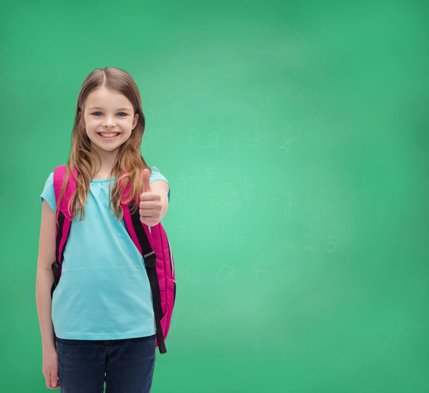 smiling girl with school bag showing thumbs up - Фото, зображення