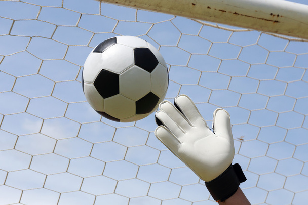 goalkeeper's hands reaching foot ball  - Photo, Image
