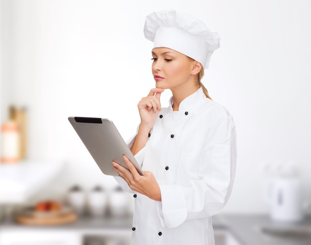 smiling female chef with tablet pc computer - Photo, Image