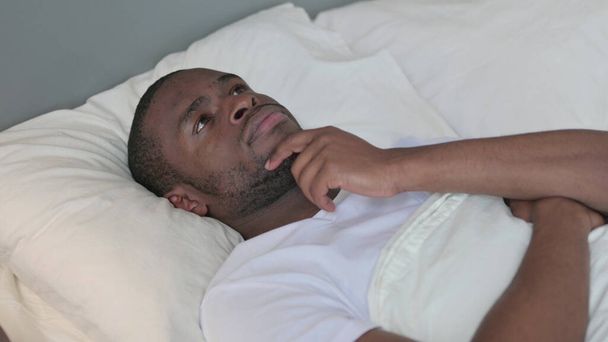 Pensive Young African Man Laying in Bed Thinking  - Photo, Image