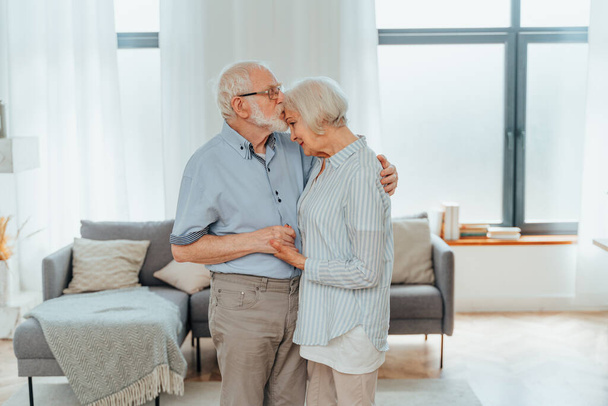 Senior couple together at home, happy moments - Elderly people taking care of each other, grandparents in love - concepts about elderly lifestyle and relationship - Valokuva, kuva
