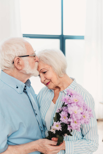Senior couple together at home, happy moments - Elderly people taking care of each other, grandparents in love - concepts about elderly lifestyle and relationship - Photo, image