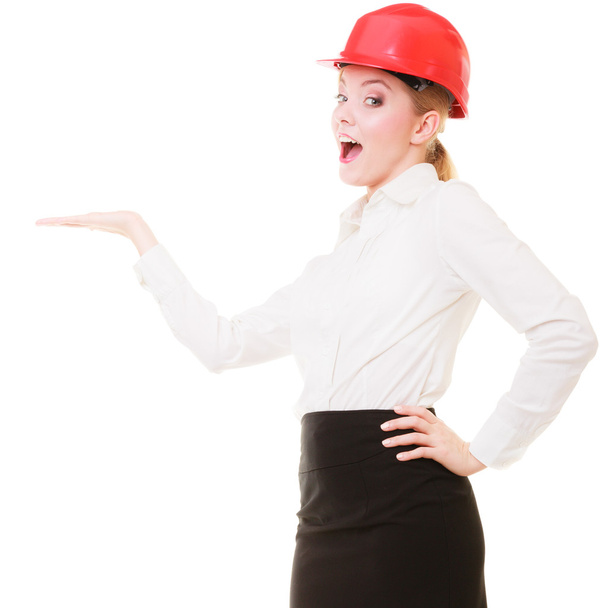 Female engineer woman architect in red safety helmet - Foto, afbeelding