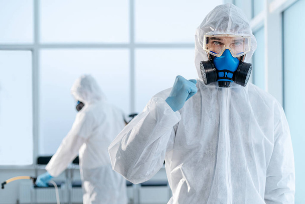 confident young disinfector standing in an infected room . - Fotó, kép
