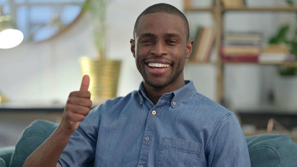 Young African Man with Thumbs Up at Home  - Photo, Image