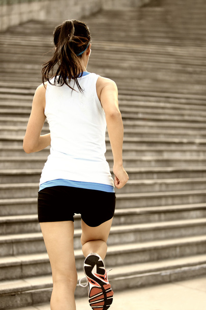 Runner athlete running on stairs. - Foto, Imagen