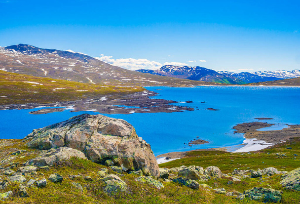 Amazing Vavatn lake panorama rough landscape view rocks boulders and mountains during summer in Hemsedal Norway. - Photo, Image