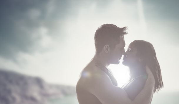Romantic kiss backlit by the sun - 写真・画像