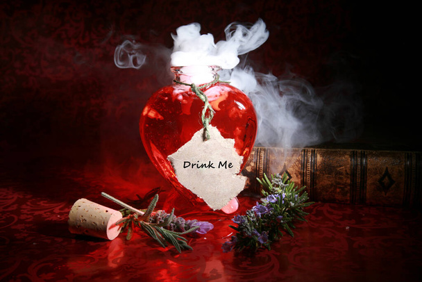 Love Potion. Magic Spell. LOVE Potion brewed up by a Gypsy, Sorceress, Fortune Teller, Witch, Match Maker, Vixen, or someone who has studied White Magic or the Dark Arts. Complete with love spell. A love potion smoking out of a heart shape bottle. - Photo, Image