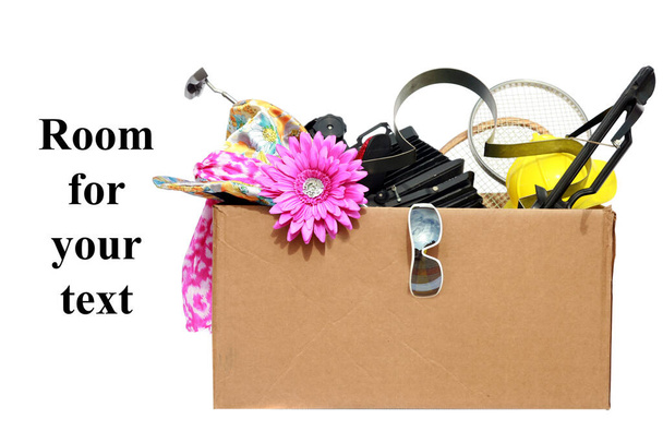Yard Sale. Tag Sale. Donation. Free. Garage Sale. Cardboard box filled with used items for sale. Isolated on white. Room for text. Clipping Path. Yard Sale items to be sold at a discount in order to make room and make some money at the same time.   - Photo, Image