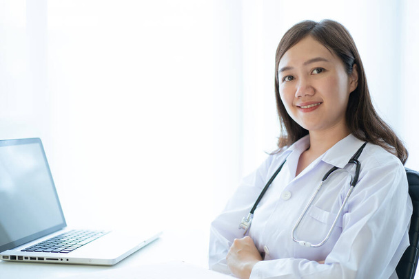 Beautiful Asian female doctor portrait in doctor office in hospital close up with copyspace. Health care worker or health care service staff in hospital. Medication officer working concept. - Foto, Imagem