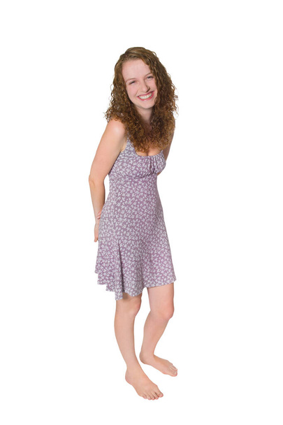 Full length portrait of a happy laughing young woman wearing a summer dress, studio photo isolated in front of white background - Zdjęcie, obraz