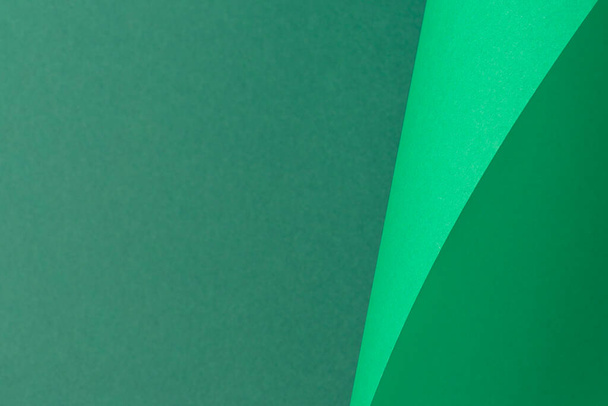 Design background curved background from green cardboard. Top view, flat lay. - Фото, изображение