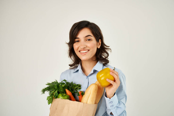 mooi brunette in blauw shirt kruidenierszakje biologisch voedsel - Foto, afbeelding