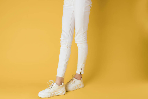 white sneakers posing modern stylish yellow background - Fotoğraf, Görsel