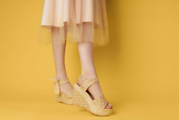 womens shoes beige yellow background posing fashion - Фото, изображение