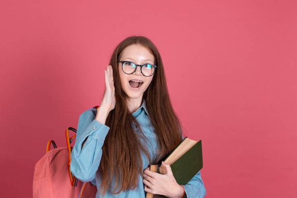 Little kid girl 13 years old isolated on pink background schoolgirl with backpack and books happy love studying education concept - Foto, Imagem