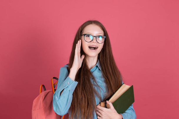 Little kid girl 13 years old isolated on pink background schoolgirl with backpack and books happy love studying education concept - 写真・画像