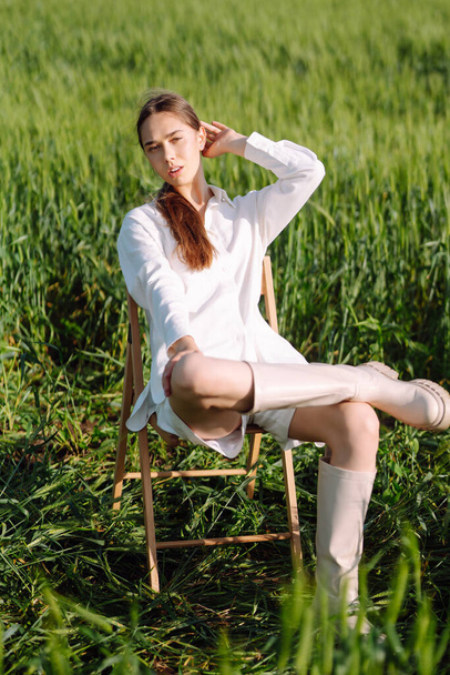 Portrait of beautiful woman in white suit posing in wheat field. Fashion and lifestyle concept. Nature, vacation, relax. Summertime. - Foto, Imagem