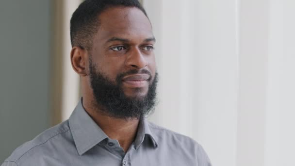 Smiling bearded millennial African guy professional looking at camera. Happy confident handsome smart young adult entrepreneur, leader, manager posing in office. Closeup face view business portrait - Footage, Video