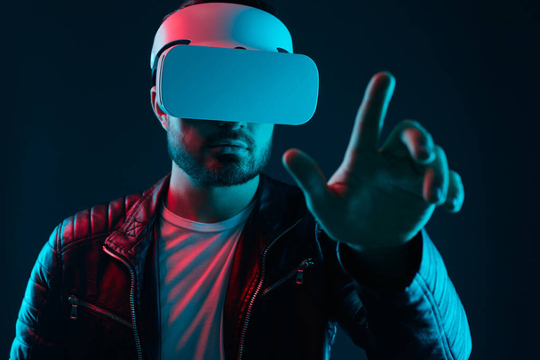 Man in VR headset interacting with virtual world - Fotoğraf, Görsel