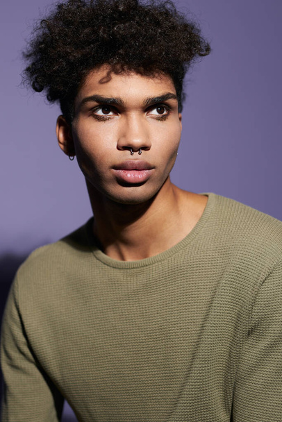 Portrait of young afroamerican transgender man with afro hairstyle and casual dress in studio - Photo, Image