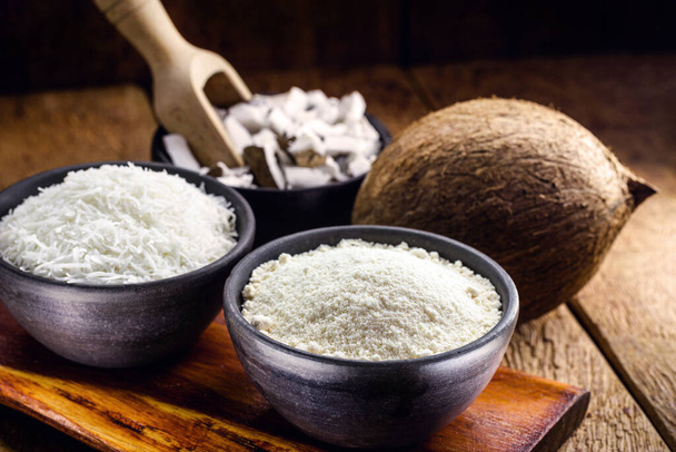 organic coconut flour, with grated coconut in the background, culinary ingredients for fruit sweets - Photo, Image