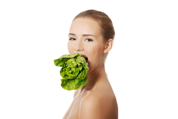Woman with lettuce in mouth - Zdjęcie, obraz