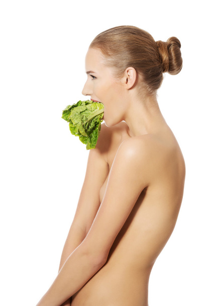 Woman with lettuce in mouth - Fotó, kép