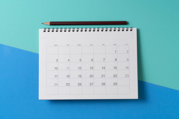close up of calendar and pencii on the green and blue table background, planning for business meeting or travel planning concept - Foto, Imagem