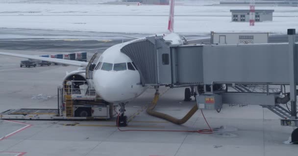 Airplane with passenger bridge on apron at engine checking - Footage, Video