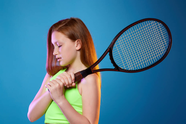 girl teenager with racket in sporswear and hat - 写真・画像