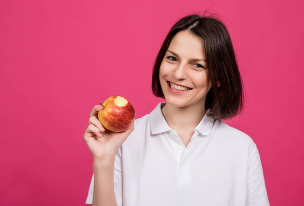 Beautiful young woman hold a big apple in her hand - Фото, зображення