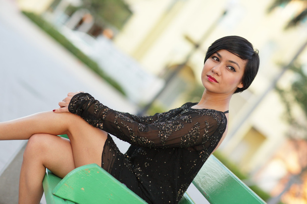 Image of a beautiful woman sitting with legs crossed - Photo, Image