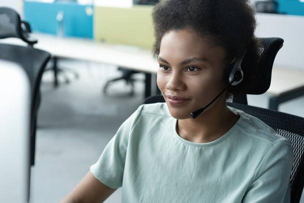 How can I help you. Beautiful call center workers in headphones are working at modern office - Foto, Imagen