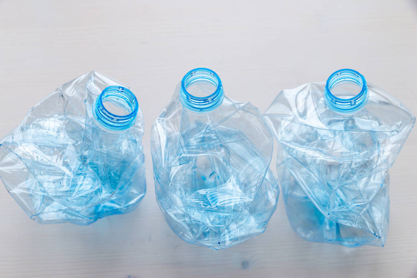 Zerkleinerte oder zerknüllte Plastikflaschen. Plastikmüll. Kunststoffrecycling. Plastikverschmutzung und Abfallmanagement.  - Foto, Bild