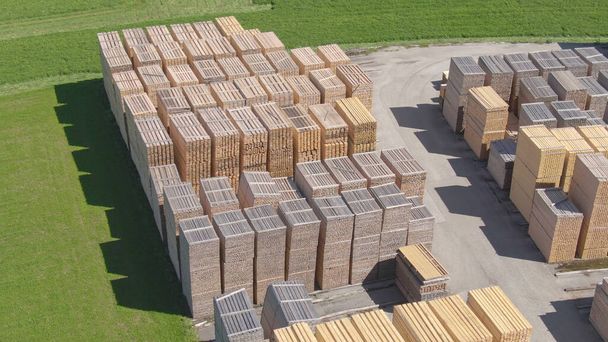 AERIAL: Flying above a neatly organized lumberyard in sunny Austrian countryside - Photo, Image