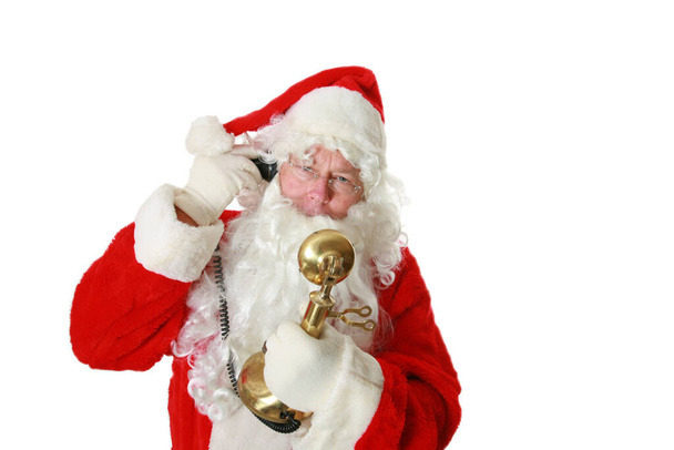 サンタクロース。クリスマスだ。電話だ。サンタクロースは電話でいい男の子と女の子に話しかける。白に隔離されてる。テキスト用の部屋。クリッピングパス。サンタクロースは電話で話す。Sサンタクロースは北極での昼食のためにピザを注文します。メリークリスマス - 写真・画像