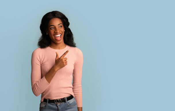 Great Offer. Cheerful Young African American Woman Pointing Finger And Looking Aside - Photo, Image