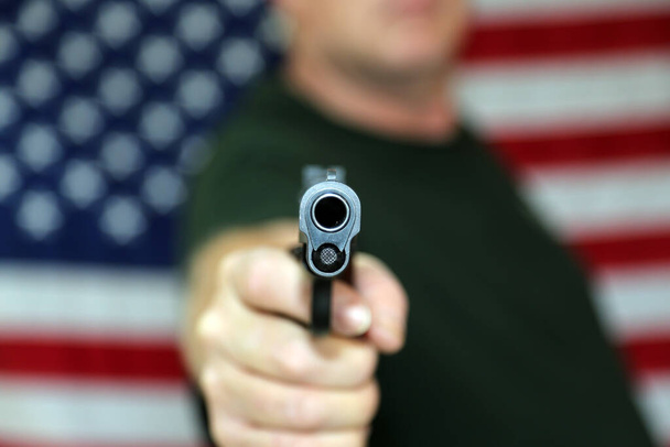 Gun. American Flag. .45 caliber pistol with an American Flag background. 2nd Amendment. Second Amendment. Represents 2nd Amendment. the right to bare arms. Civil Liberty. Personal Protection. Protection of life and property. Gun Control. Pistol.  - Foto, Imagem