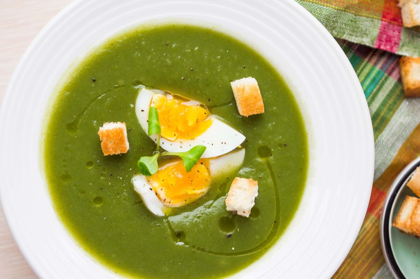Green spring, summer healthy cream soup with herbs, egg, crouton - 写真・画像