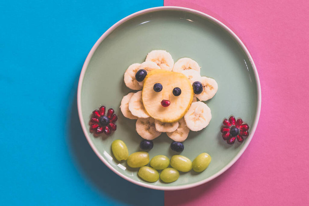 Happy Easter concept on plate, sheep from banana fruit full of vitamins on plate, isolated on blue and pink backgrounds - Foto, Imagen