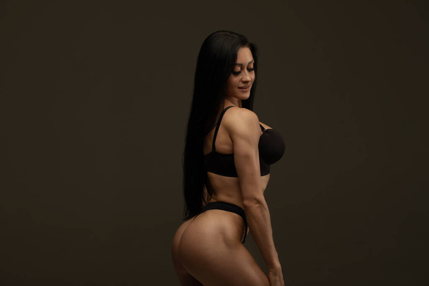 beautiful sexy young woman in black underwear posing in studio - Фото, зображення
