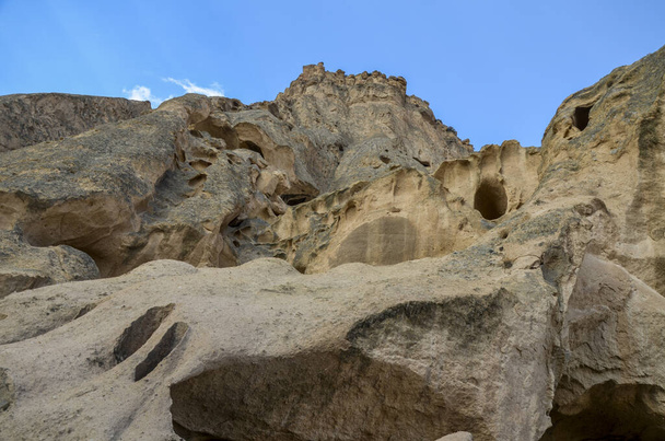 The caves of the ancient rock monastery of Selime, carved into the mountains in the valley of Ihlara, Cappadocia, Turkey - Photo, Image